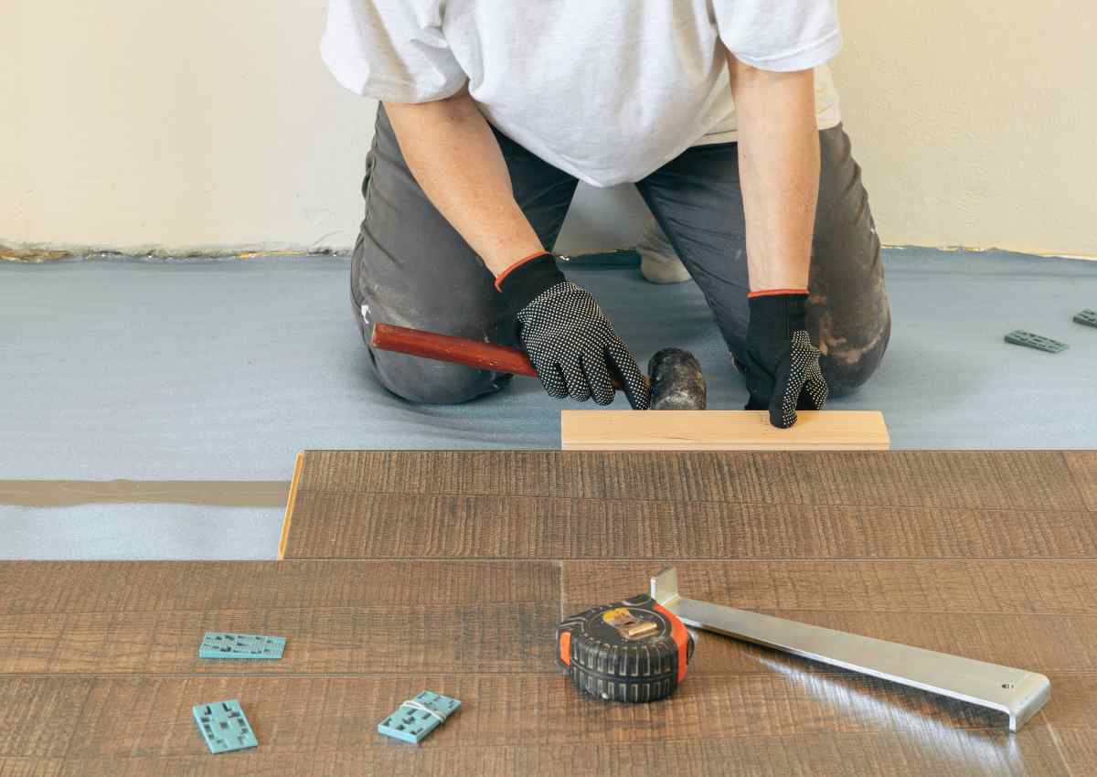 Using tapping block for installing vinyl flooring.